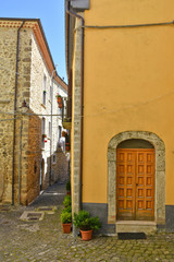 Fototapeta premium Castel San Vincenzo, Italy, 07/12/2018. A narrow street between the houses of a village in the Molise region