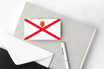 Jersey flag on minimalist letter background. National invitation envelope with white pen and...