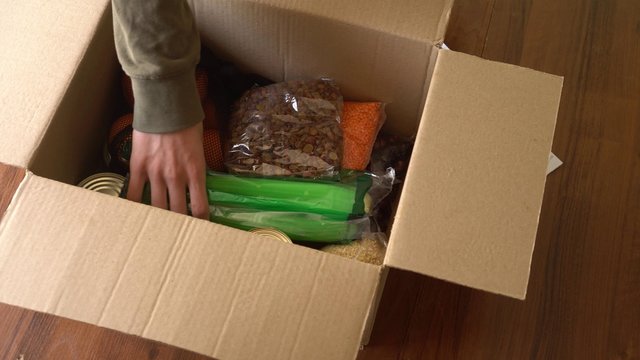 Ordering Food, Groceries, Vegetables And Fruit From An Online Store. Food Delivery, Online Shopping Concept. Unpacking A Parcel Box. Home Self-isolation During The Coronavirus Pandemic