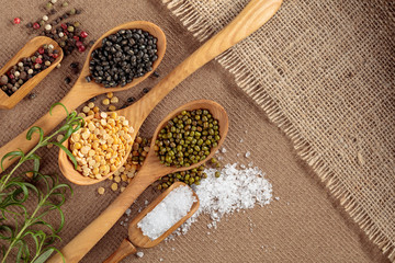 Various raw lentils with rosemary, salt and pepper.
