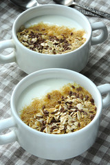 Two bowls with white yogurt, bran and seeds. Healthy breakfast. Diet food.