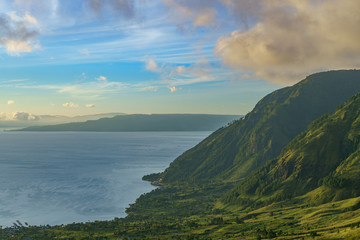 Beautiful slopes of lake Toba in early morning golden hour sunrise remarkable location for hiking, photography, camping