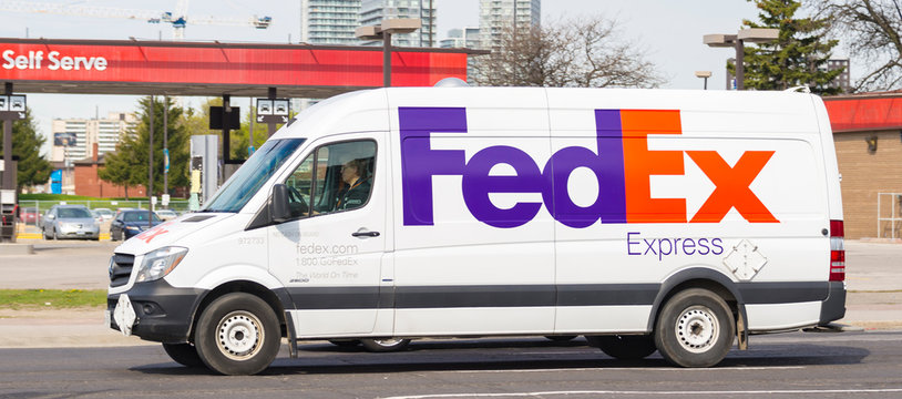 Fedex truck driving in the city, Toronto, Canada
