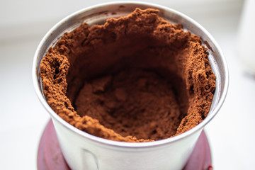 Ground coffee in a coffee grinder