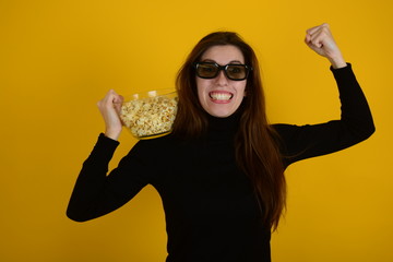 woman in black sweater with popcorn in hand