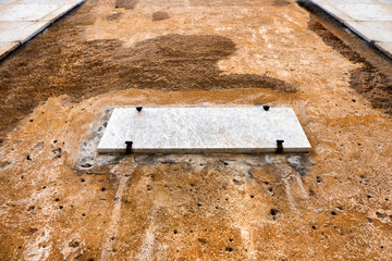 Concrete slab on a rusty wall
