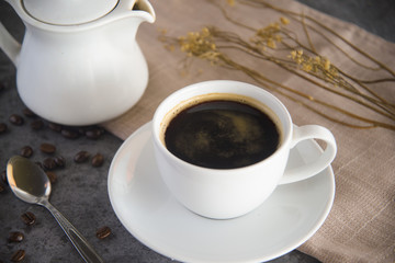 Coffee cup and coffee beans on table