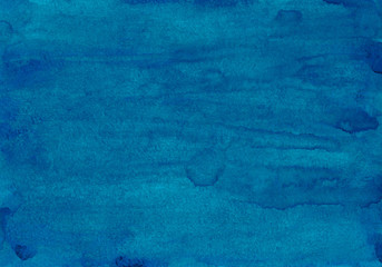 Watercolor deep blue background texture. Hand painted aquarelle backdrop. Stains on paper abstract painting. Liquid wallpaper.