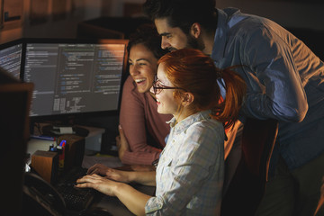 	
Team of programmers working on new project.They working late at night at the office.	
