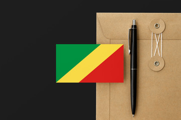 Republic Of The Congo flag on craft envelope letter and black pen background. National invitation...