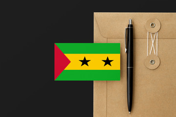 Sao Tome And Principe flag on craft envelope letter and black pen background. National invitation...
