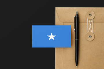 Somalia flag on craft envelope letter and black pen background. National invitation concept. Invitation for education theme.