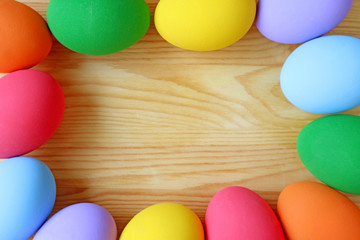 Top View of Colorful Easter Eggs on Wooden Background with Copy Space