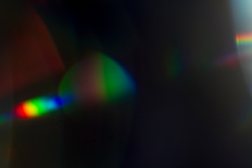 Lens flare and light leak haze texture on a black background.