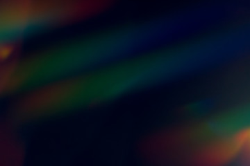 Lens flare and light leak haze texture on a black background.