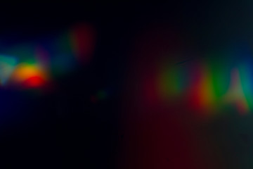 Lens flare and light leak haze texture on a black background.