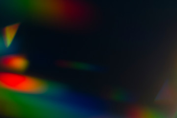 Lens flare and light leak haze texture on a black background.
