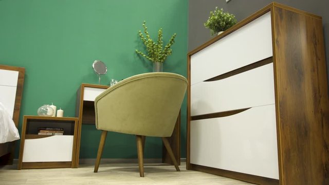 Stylishly furnished bedroom with a trendy mirror chair and wooden table