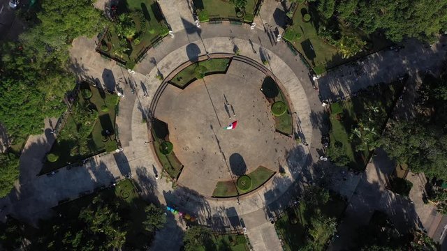 Aerial view straight down ascending over the Zocalo, Plaza Grande in Merida, Yucatan, Mexico with long shadows.