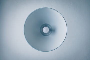 metal lamp seen from below and white ceiling
