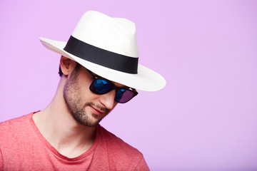Closeup portrait of awesome hipster wearing fedora hat with intense look at camera. Headshot over...