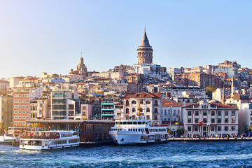 Fototapeta premium Istanbul cityscape in Turkey with Galata Kulesi Tower. Ancient Turkish famous landmark in Beyoglu district, European side of city. Architecture of the Constantinople.Historical place made by Genoese