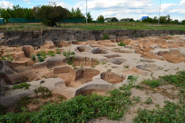 field with pits from the excavations of the ancient city