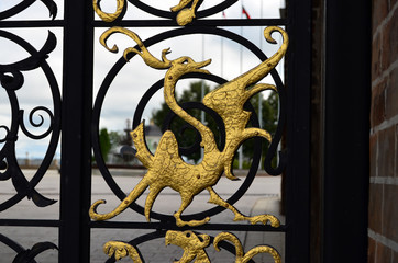 forged image of a golden animal on the fence
