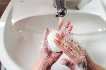 Man washing hands to protect against the coronavirus