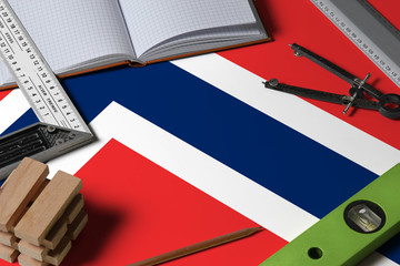 Fototapeta na wymiar Norway national flag on profession concept with architect desk and tools background. Top view mock-up.