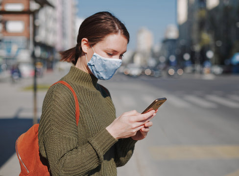 Young Woman Using Smart Phone In The City Wearing Face Mask Protection For Virus Coronavirus Covid 19