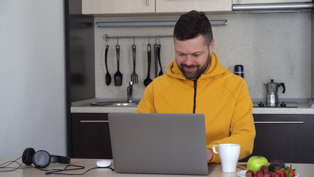 Man works on laptop at home