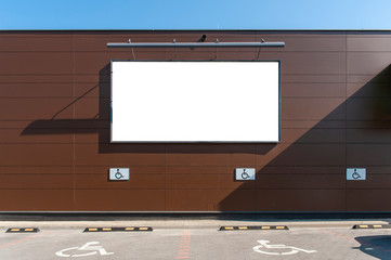 Blank white advertising billboard on the wall of the store