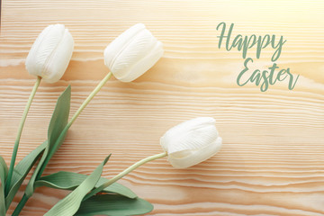 Easter eggs and tulips on a wooden table. Morning light.