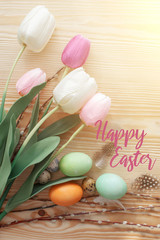 Easter eggs and tulips on a wooden table. Morning light.