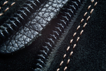 Black zipper on black leather boots..