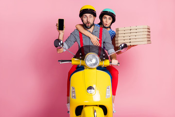 Portrait of nice attractive cheerful friends friendship driving moped carrying sweet pie baked dessert cell online order new app pout lips isolated over pink pastel color background