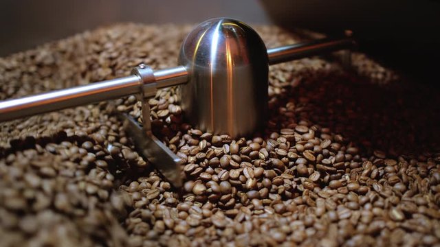 Closeup Selective focus coffee roaster with coffee beans.