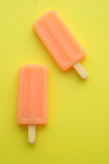 top view of ice cream on yellow background 