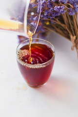 White background, strong, morning, specialty coffee brewed by an alternative method from gadget. Bouquet of field flowers and glassware.