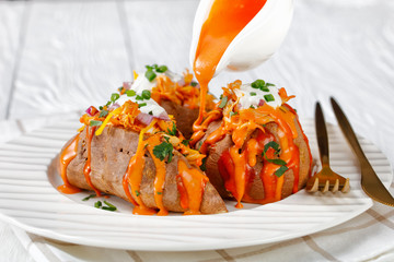 Sweet potato with chicken with sour cream on top