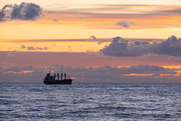 Fototapeta premium cargo ship at sunset. Black sea