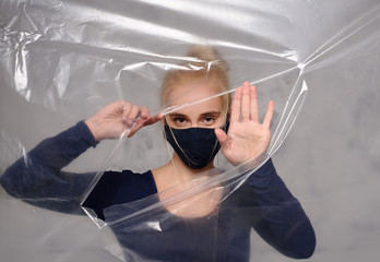 Quarantined woman wears a protective mask.
Quarantined woman breakthrough of oilcloth.