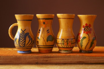 Background with wooden jugs with romanian pattern	