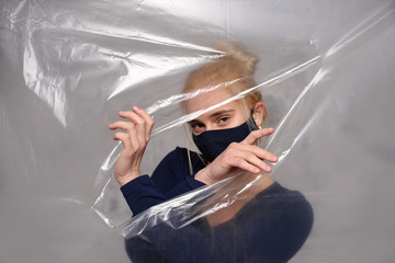 Quarantined woman wears a protective mask.
Quarantined woman breakthrough of oilcloth.
