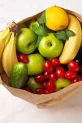 fruits, vegetables, wine in a paper bag
