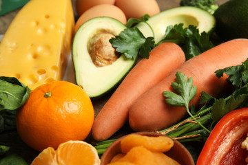 Fresh products rich in vitamin A on table, closeup