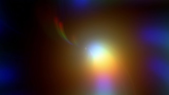 A slow, beautiful, colorful rainbow lens flare, moving from the upper left to the lower right of the screen, becoming a white glow at the center.