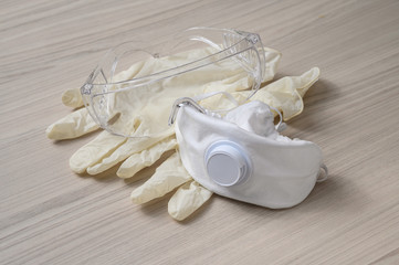 Personal protective equipment against the virus, on a wooden table
