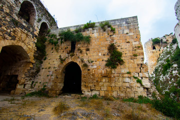 Krak (Crac) des Chevaliers, also called (‎Castle of the Kurds), and formerly Crac de l'Ospital, is a Crusader castle in Syria and one of the most important preserved medieval castles in the world. - obrazy, fototapety, plakaty